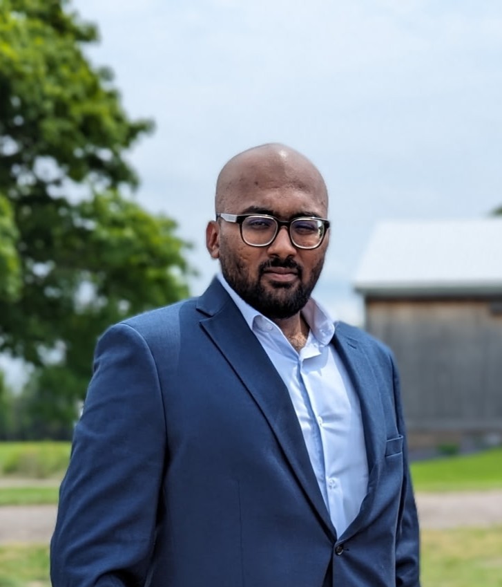 Joel wearing a blue suit outdoors